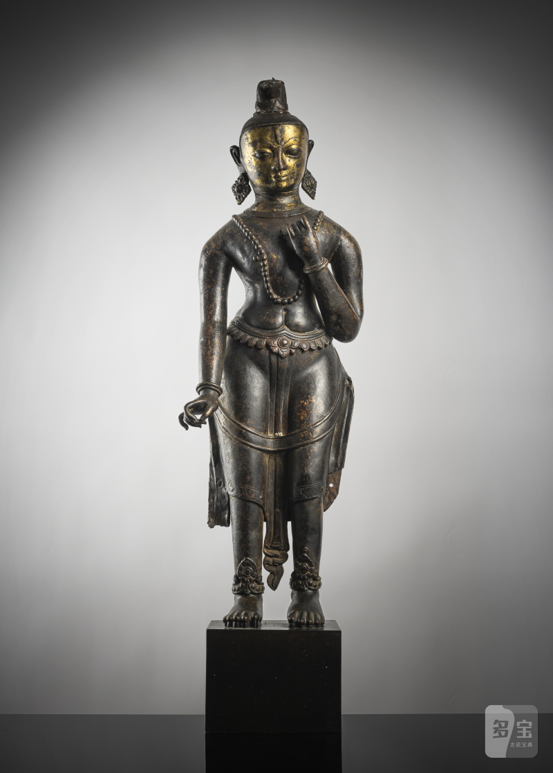 A large cast and repoussé figure of a standing deity